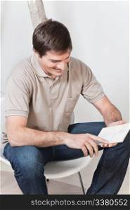 Young attractive man looking at color guide and smiling