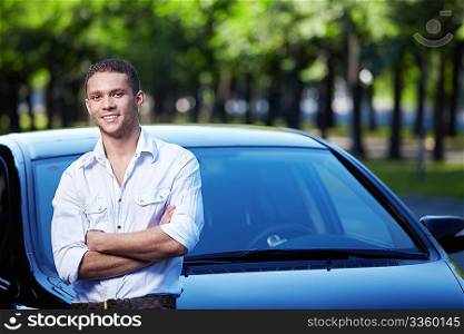 Young attractive man with car