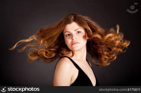 Young attractive model flicking very long hair