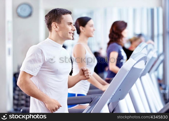 Young attractive people in the fitness club