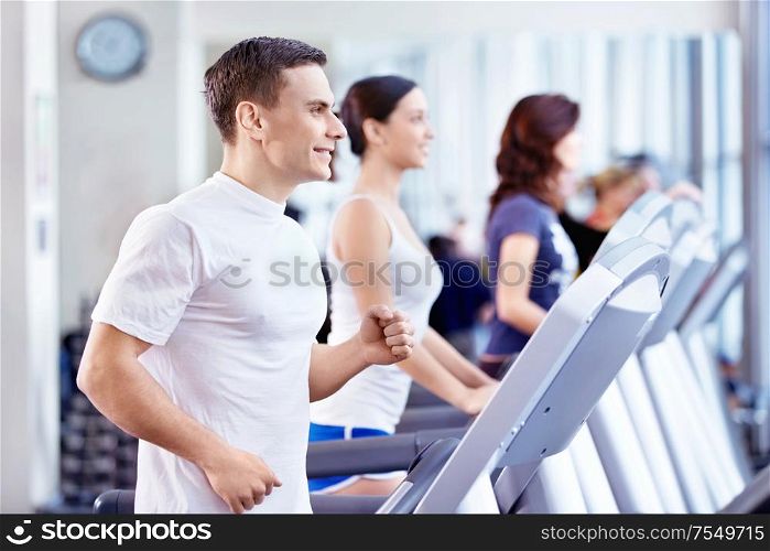 Young attractive people in the fitness club
