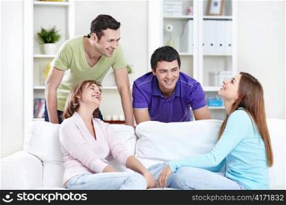 Young attractive people laugh in the apartment