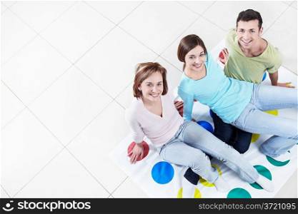 Young attractive people playing twister