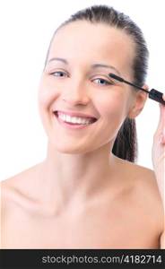 young attractive sensual woman is applying cosmetics on her face and looking at camera, isolated on white