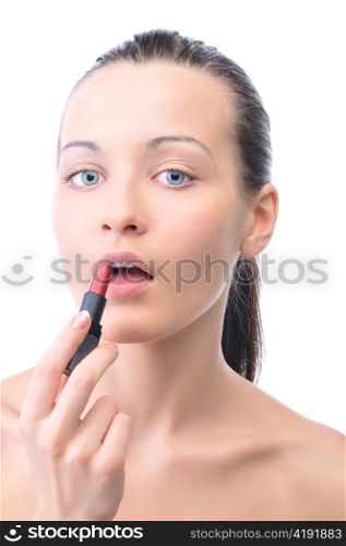 young attractive sensual woman is applying cosmetics on her face and looking at camera, isolated on white