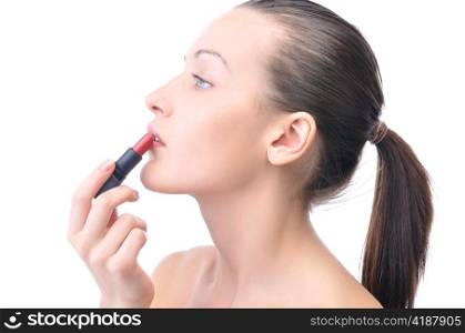 young attractive sensual woman is applying cosmetics on her face, side view, isolated on white