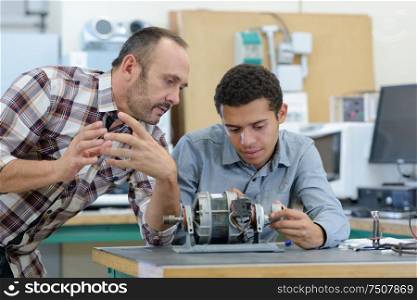 young attractive students of mechatronics working on project