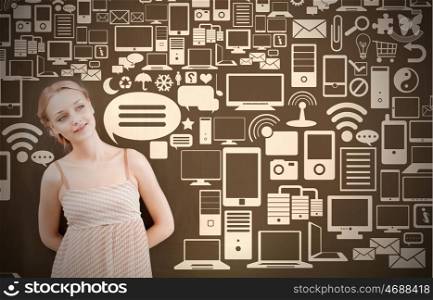Young attractive thoughtful woman in dress standing at blackboard . Cloud connection concept
