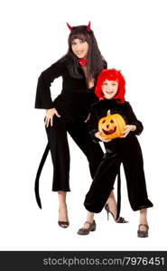 Young Attractive Woman and little Girl Standing in the Halloween Costumes of Black Devils with Jack O&rsquo; Lantern,