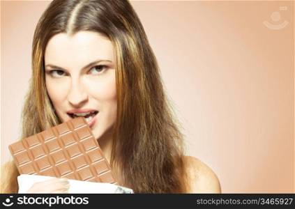 Young attractive woman eating chocolate. studio shot
