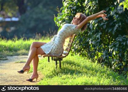 young attractive woman enjoying the sun in the park