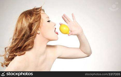 Young attractive woman holding a lemon