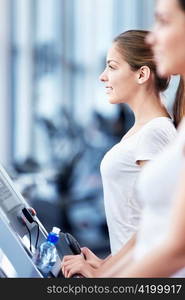 Young attractive woman in the fitness club