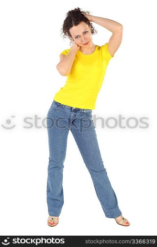 young attractive woman in yellow shirt and jeans standing, hands behind head on white