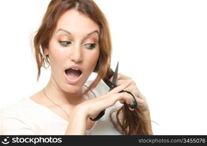 young attractive woman is cutting her hair, over white