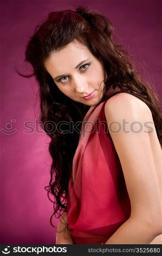 young attractive woman on a pink background