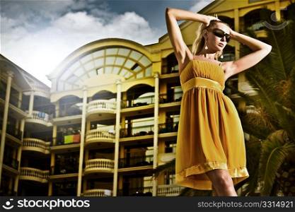 Young attractive woman over hotel in the evening