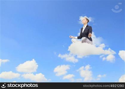 Young attractive woman sitting on cloud and meditating. Take a break and relax