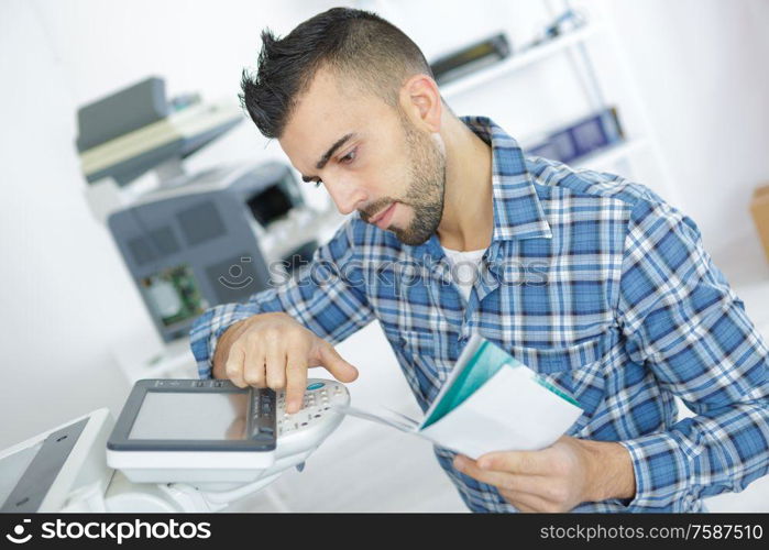 young attractive worker man working using printmaking device