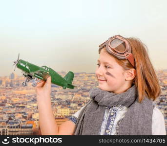 young aviator playing with toy airplane