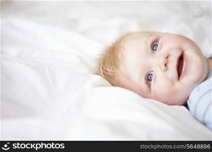 Young Baby Boy Lying In Bed