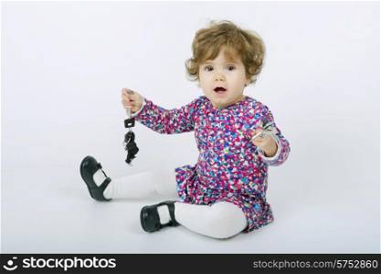 young baby with keys on a grey background
