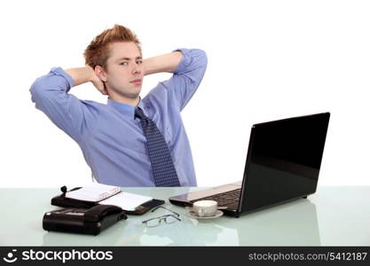 Young banker in front of a computer