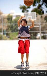 Young basketball player jumping high in air