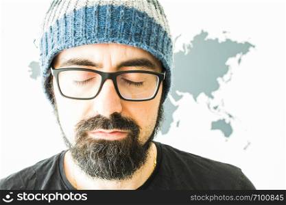 Young bearded man on white background with world map