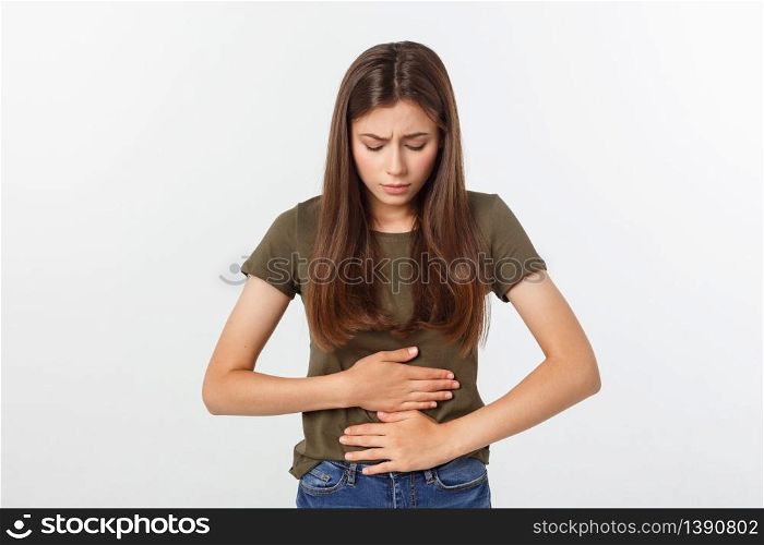 Young beautiful asian woman having painful stomachache on white background. Young beautiful asian woman having painful stomachache on white background.
