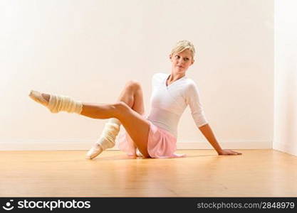 Young beautiful ballerina exercising in the studio woman ballet dancer
