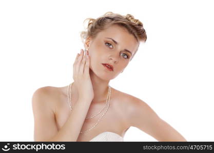 Young beautiful blond girl with a wedding hairstyle. Portrait of the bride on a white background isolated