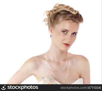 Young beautiful blond girl with a wedding hairstyle. Portrait of the bride on a white background isolated