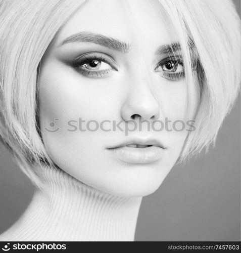 Young beautiful blonde. Portrait of sexy woman. Attractive model with classic style hairstyle. Pretty girl with professional makeup and hairdress.