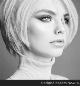 Young beautiful blonde. Portrait of sexy woman. Attractive model with classic style hairstyle. Pretty girl with professional makeup and hairdress.