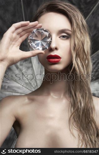 Young beautiful blonde with big diamond. Erotic portrait of sexy woman. Attractive model with classic style hairstyle. Pretty girl with professional makeup and hairdress.