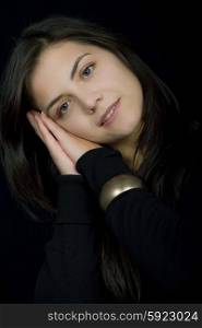young beautiful brunette portrait against black background