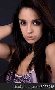 young beautiful brunette portrait against black background