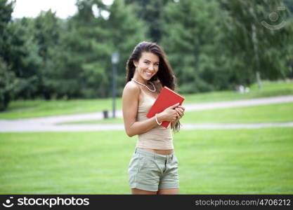 Young beautiful brunette woman and holds book