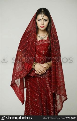 Young beautiful brunette woman in indian red dress