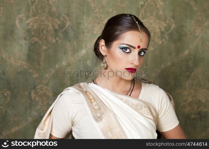 Young beautiful brunette woman in indian white dress