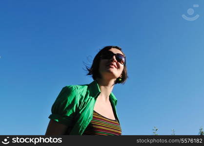 young beautiful brunette woman jump outdoor in fashion clothing and sunglasses