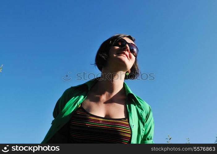 young beautiful brunette woman jump outdoor in fashion clothing and sunglasses