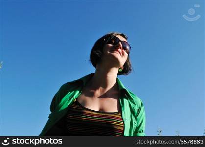 young beautiful brunette woman jump outdoor in fashion clothing and sunglasses