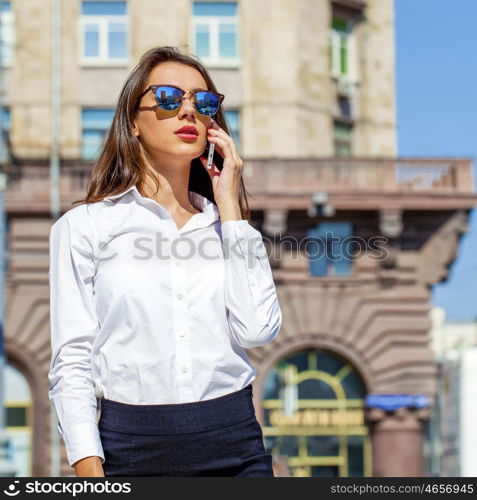 Young beautiful business woman talking on mobile phone