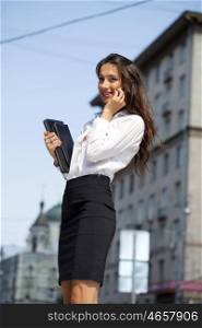 Young beautiful business woman talking on mobile phone