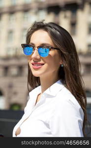 Young beautiful business woman with blue mirrored sunglasses