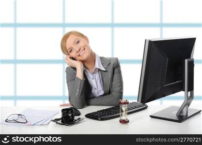 Young beautiful businesswoman in the office said by telephone