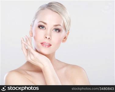 young beautiful caucasian woman with natural makeup posing in the studio