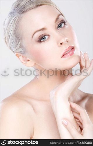 young beautiful caucasian woman with natural makeup posing in the studio